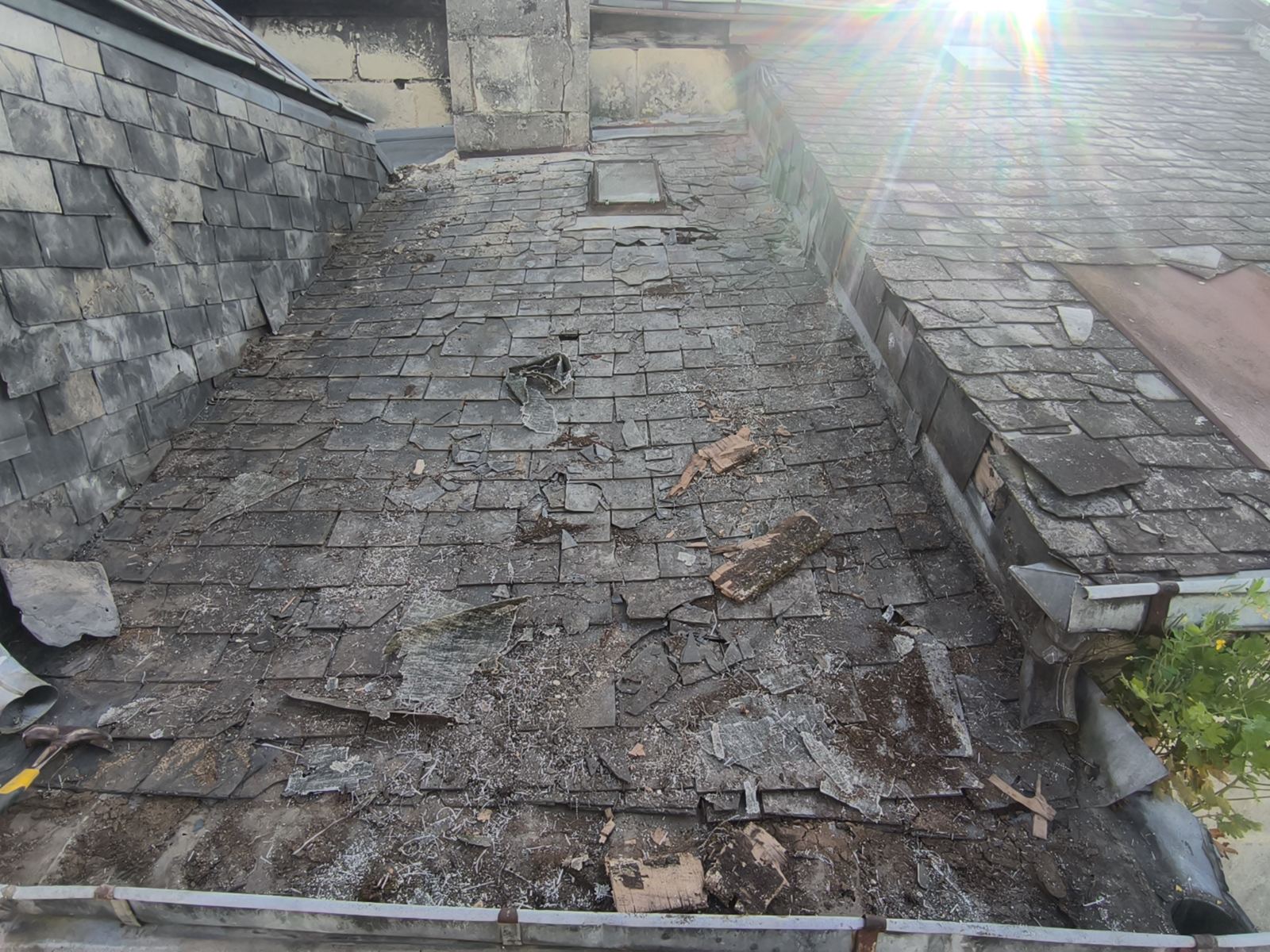 Ancienne toiture en ardoise encombrée de débris